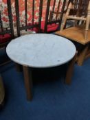 A teak and marble circular table