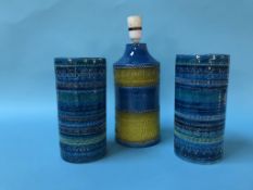 A blue and yellow pottery table lamp and a pair of vases