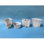 Four various pottery jelly moulds