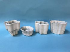 Four various pottery jelly moulds