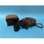 A mahogany pin cushion and a pair of binoculars
