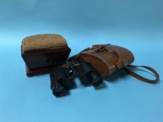 A mahogany pin cushion and a pair of binoculars