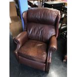 A brown leather recliner armchair