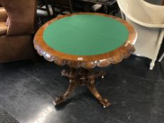 A Victorian walnut and marquetry demi lune fold over card table