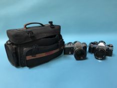 A Canon AE 1 and a Nikon F2-8037296