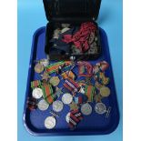 A large collection of World War I and World War II service medals, together with a quantity of