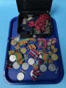 A large collection of World War I and World War II service medals, together with a quantity of