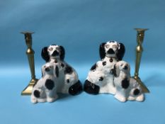 Two pairs of Staffordshire dogs and a pair of brass candlesticks