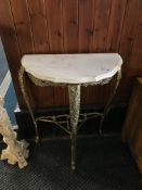 A half moon marble top console table