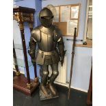 A reproduction suit of medieval armour and a sword