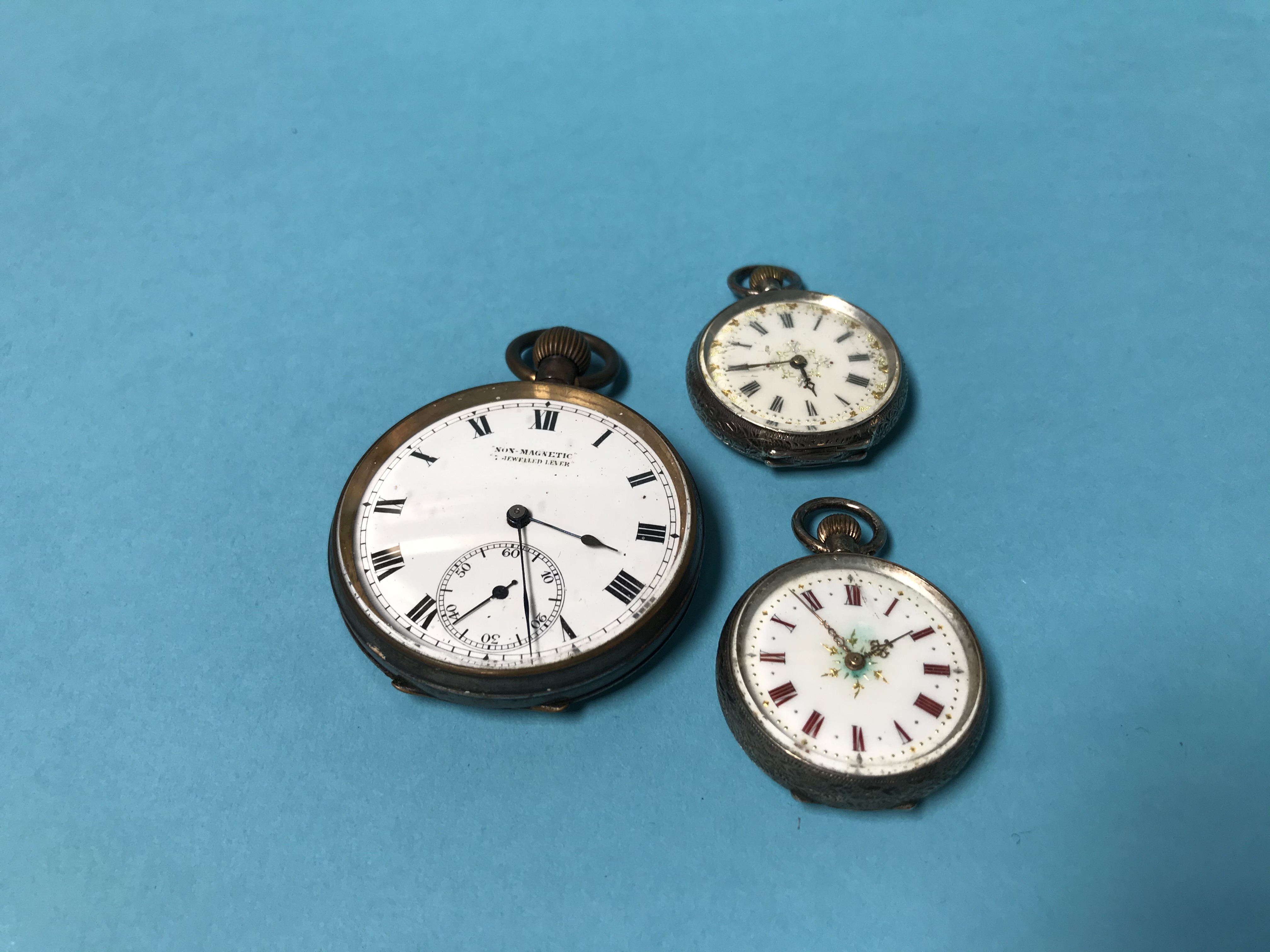 A gunmetal pocket watch and two others