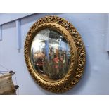 A convex gilt edged mirror