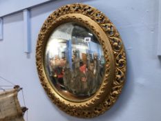 A convex gilt edged mirror