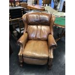 A tan brown leather recliner armchair