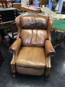 A tan brown leather recliner armchair