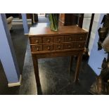 A 1940s oak filing chest, with ten small drawers