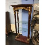 An Empire style glass shelving unit