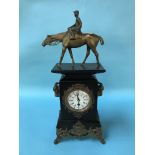 A slate mantel clock, surmounted with a brass horse and Jockey