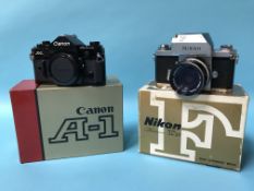 A boxed Canon A-1 and a Nikon F