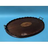 An Edwardian mahogany oval two handled tea tray