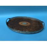 A walnut and pierced oval two handled tea tray