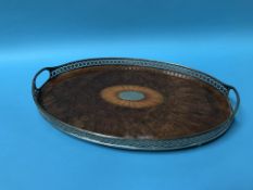 A walnut and pierced oval two handled tea tray