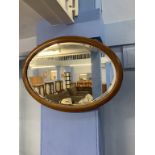 An Edwardian oval wall mirror