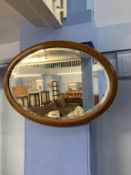 An Edwardian oval wall mirror