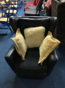 A Vintage black leather armchair by Howard Keith