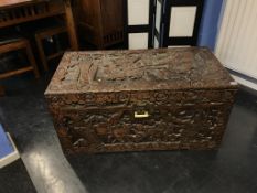 An Oriental carved camphorwood chest