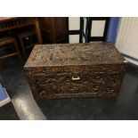 An Oriental carved camphorwood chest