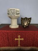 An octagonal marble font, 38cm high and a silver mounted oak shield