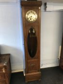 An oak long case clock