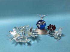 Four boxed Swarovski ornaments to include 'Crystal Planet Version 2000', a squirrel and two flower