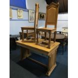 An ecclesiastical oak altar table and a pair of oak chairs