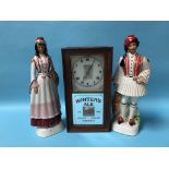 An Advertising wall clock 'Hunters Ales' and a pair of Italian figures