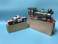 A boxed tin plate police car and Western special locomotive