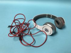 A pair of Solo HD Beats by Dre headphones and case