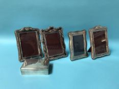 A silver cigarette box, silver photo frame and three others