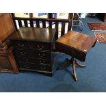 A small reproduction chest of drawers and an occasional table
