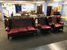 An oxblood Chesterfield high back three piece suite