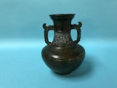 A Chinese two handled bronze vase, marks to base, 22cm height