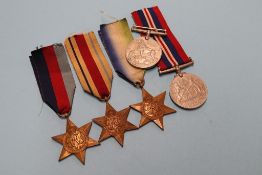 A group of five unnamed World War II medals, to include Africa and Atlantic stars