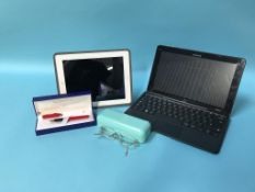 A laptop, I-Pad, Waterman pen and a pair of Tiffany glasses