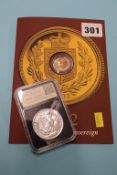 A 2002 Golden Jubilee Sovereign and a commemorative silver coin