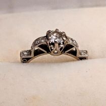 An Art Deco diamond ring, stamped Plat, 3.6g, size 'O', central stone approx. 0.5ct, 1.25cts total