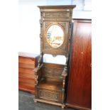 A Victorian carved oak mirror back hallstand by L. H. Gullachsen of Newcastle Upon Tyne (1885-1887),