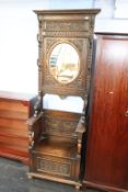 A Victorian carved oak mirror back hallstand by L. H. Gullachsen of Newcastle Upon Tyne (1885-1887),