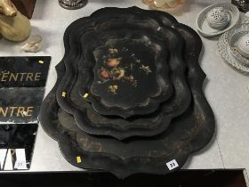 A set of three Victorian graduated papier mache trays, 70 x 59cm largest