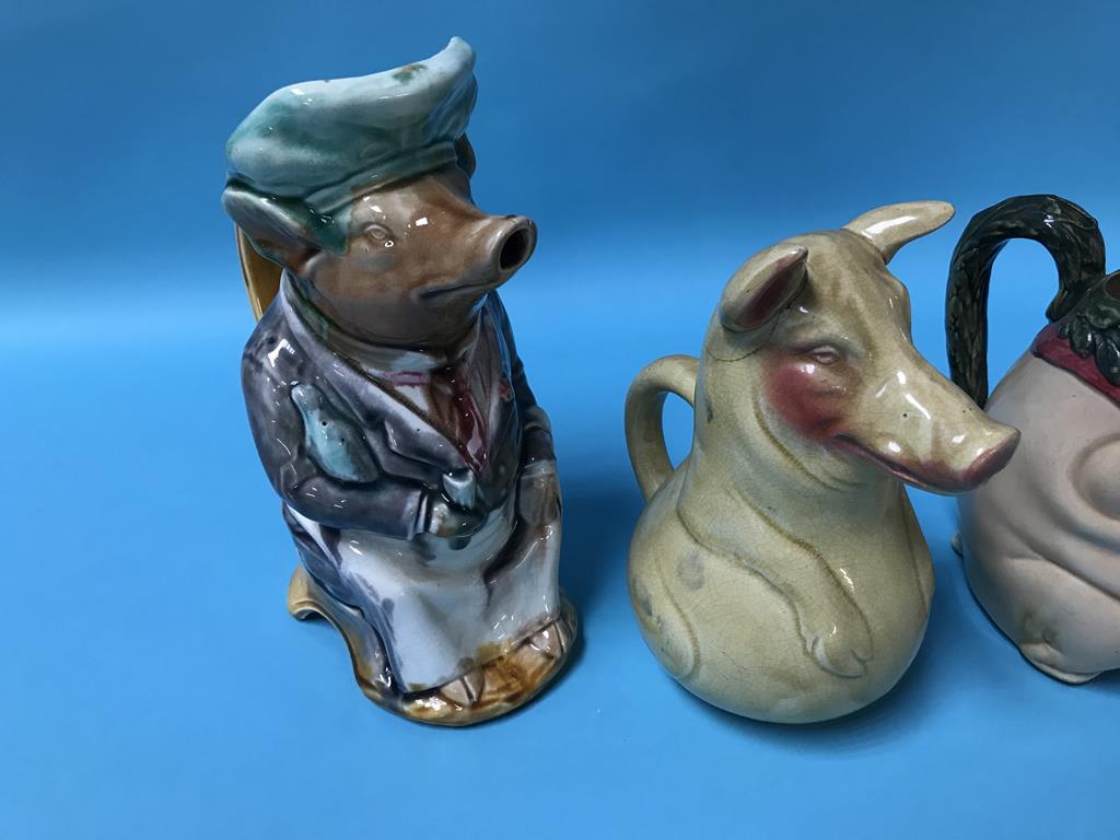 A French majolica water jug in the form of a dressed seated pig and three other pig form jugs (4) - Image 2 of 3